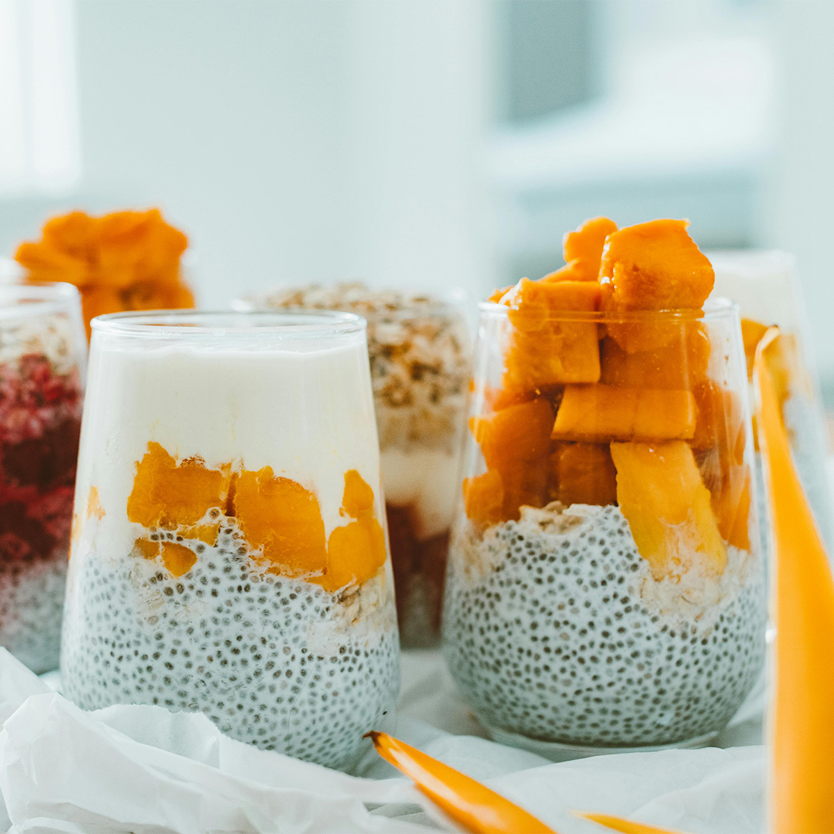 Glasses of chia pudding with mango — tropical freshness and natural color.