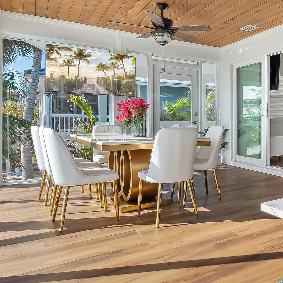 Bright indoor dining area at Casa Amorsol with modern chairs, natural wood ceiling, and garden views